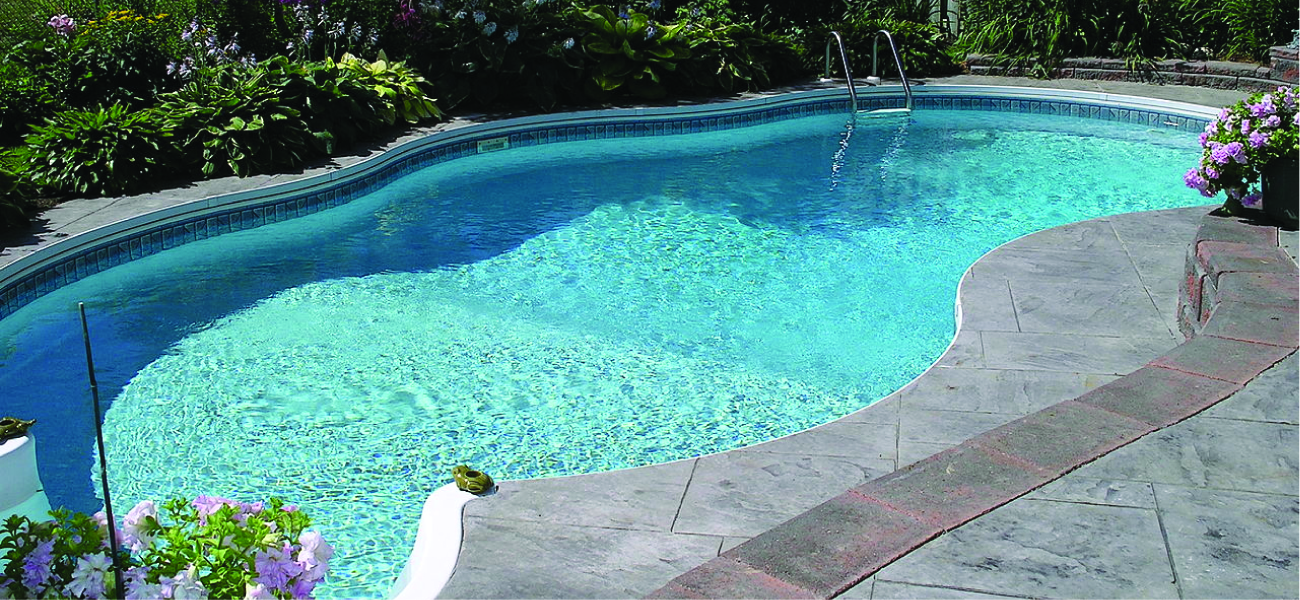 This figure shows a swimming pool that is full of water and surrounded by a concrete patio.